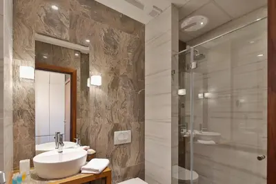 a bathroom with a sink and a shower at Passpartu Garni hotel Rooms in Belgrade