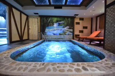 a jacuzzi tub in the middle of a house at Passpartu Garni hotel Rooms in Belgrade