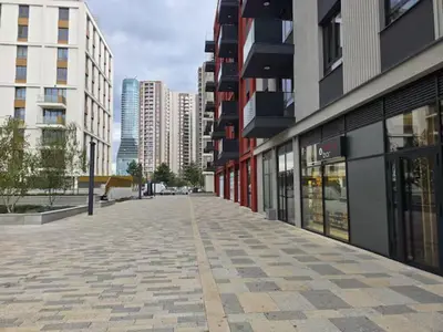 an empty street in a city with tall buildings at Hercules Apartment Belgrade Waterfront in Belgrade