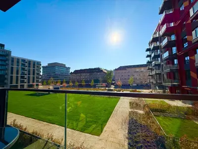 a view of a green field from a balcony at Hercules Apartment Belgrade Waterfront in Belgrade