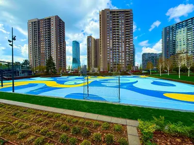 a basketball court in a park with tall buildings at Hercules Apartment Belgrade Waterfront in Belgrade