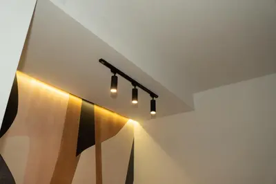 a hallway with a row of lights on the ceiling at Aster Apartmani in Belgrade