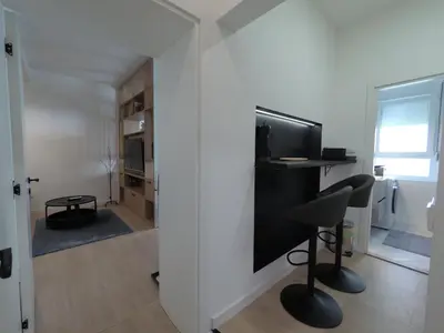 a room with a desk and a chair and a television at Aster Apartmani in Belgrade