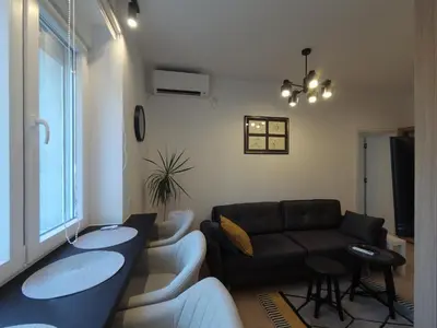 a living room with a couch and a table at Aster Apartmani in Belgrade