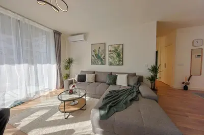 a living room with a couch and a table at Eternal Lux Belgrade Waterfront in Belgrade