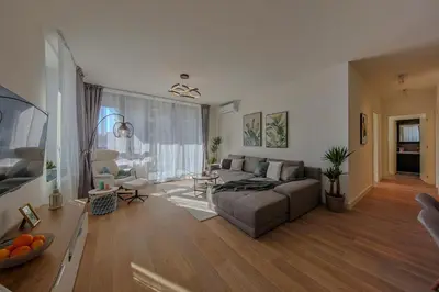 a living room with a couch and a table at Eternal Lux Belgrade Waterfront in Belgrade