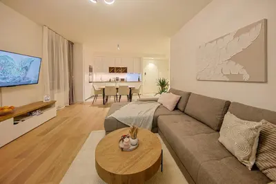 a living room with a couch and a table at Eternal Lux Belgrade Waterfront in Belgrade