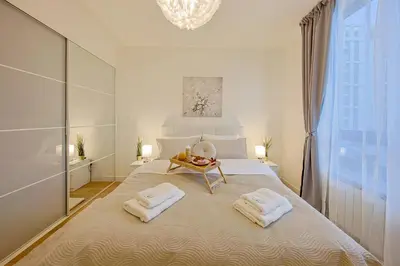 a bedroom with a large bed with towels on it at Eternal Lux Belgrade Waterfront in Belgrade