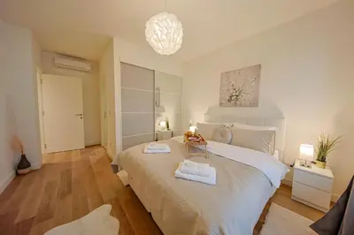 a bedroom with a bed with two towels on it at Eternal Lux Belgrade Waterfront in Belgrade