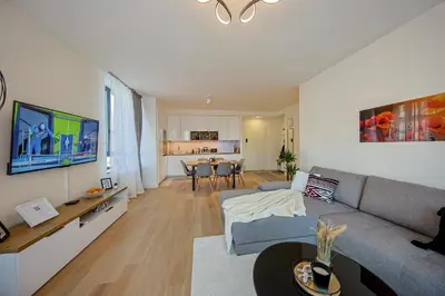 a living room with a couch and a table at Eternal Lux Belgrade Waterfront in Belgrade