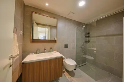 a bathroom with a toilet and a sink and a shower at Eternal Lux Belgrade Waterfront in Belgrade