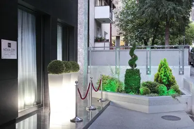 a balcony with green plants on a building at Nova City Garni Hotel Signature Collection in Belgrade