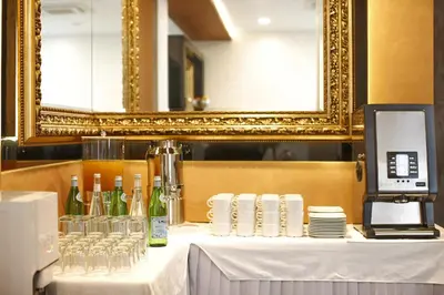 a table with wine bottles and glasses on it at Nova City Garni Hotel Signature Collection in Belgrade