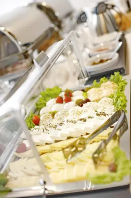a buffet of food with vegetables and cheese at Nova City Garni Hotel Signature Collection in Belgrade