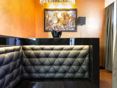 a bar with a leather bench in a room at Nova City Garni Hotel Signature Collection in Belgrade
