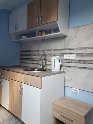 a small kitchen with a sink and a counter at A3 small cute single room in Pančevo