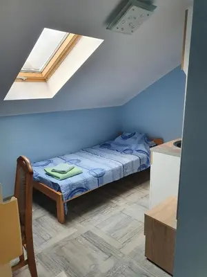 a small bedroom with a bed in a room at A3 small cute single room in Pančevo