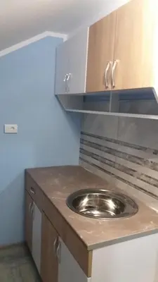 a kitchen with a stainless steel sink on a counter at A3 small cute single room in Pančevo