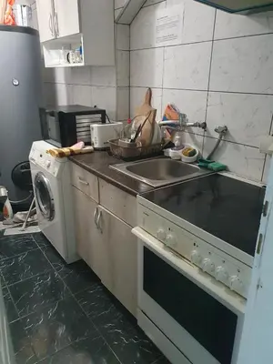 a kitchen with a sink and a washing machine at A3 small cute single room in Pančevo