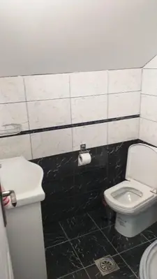 a bathroom with a white toilet and a sink at A3 small cute single room in Pančevo