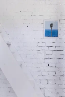 a picture of a palm tree on a white brick wall at Charming attic in the heart of the city in Belgrade