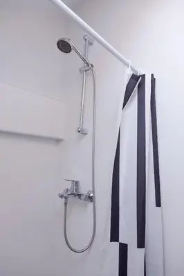 a shower in a bathroom with a black and white tie at Charming attic in the heart of the city in Belgrade