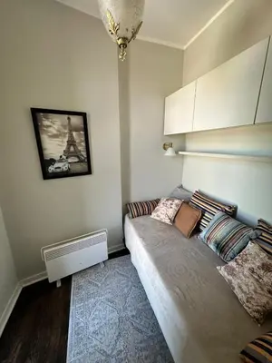 a bedroom with a bed with pillows on it at Yulia's beautiful studio in Belgrade