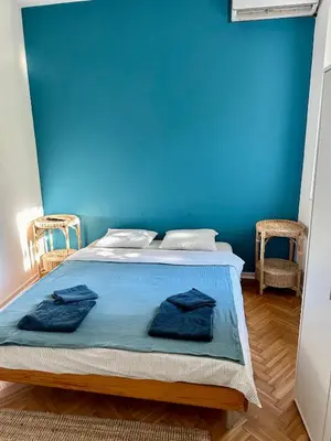 a blue bedroom with a bed with blue walls at Historic Charm Peaceful and Cozy in Belgrade