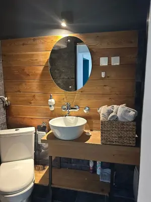 a bathroom with a sink and a toilet and a mirror at Historic Charm Peaceful and Cozy in Belgrade