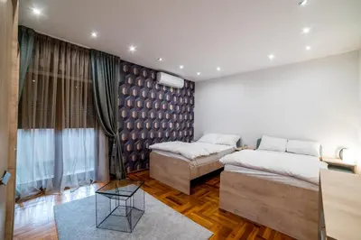 a bedroom with two beds and a couch at Alrawda Resort in Mala Ivanča
