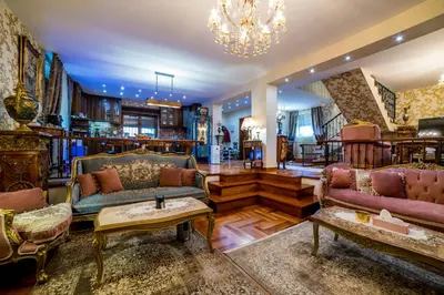 a living room with couches and a chandelier at Alrawda Resort in Mala Ivanča