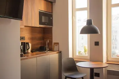 a small kitchen with a table and a table and chairs at Riverside Heritage Lux and Modern 3 in Belgrade