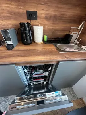 a coffee machine sitting on a counter next to a sink at Riverside Heritage Lux and Modern 3 in Belgrade