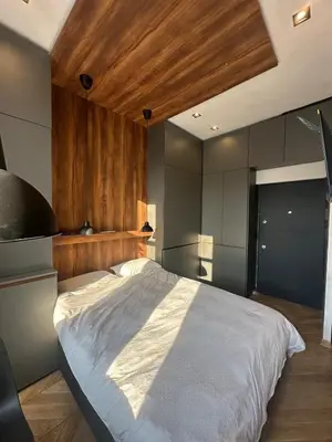 a bedroom with a large bed with a wooden ceiling at Riverside Heritage Lux and Modern 3 in Belgrade