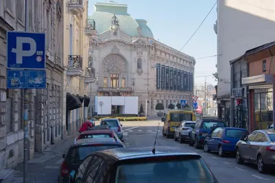 a city street with cars parked in front of a building at Riverside Heritage Lux and Modern 3 in Belgrade