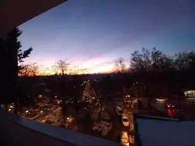 a view of a city at sunset from a balcony at Urban Panorama in Belgrade