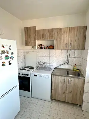 a kitchen with a white refrigerator and a sink at Urban Panorama in Belgrade