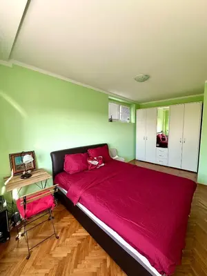 a bedroom with a large red bed and a desk at Urban Panorama in Belgrade