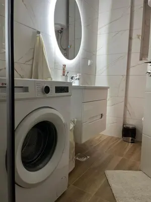 a washing machine in a bathroom with a mirror at Apartman Relax in Arandjelovac