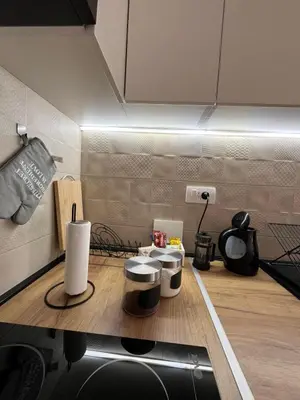 a kitchen with a counter with three drums on it at Apartman Relax in Arandjelovac