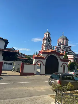 a church with a car parked in front of it at Apartman Relax in Arandjelovac