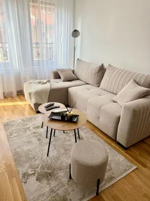 a living room with a couch and a coffee table at Apartman Relax in Arandjelovac