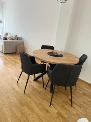 a dining room table with chairs and a bowl on it at Apartman Relax in Arandjelovac