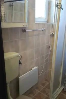 a bathroom with a toilet and a window at Studio Apartman Grof in Belgrade