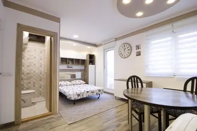 a bedroom with a table and a bed in a room at Studio Apartman Valdez 2 in Belgrade