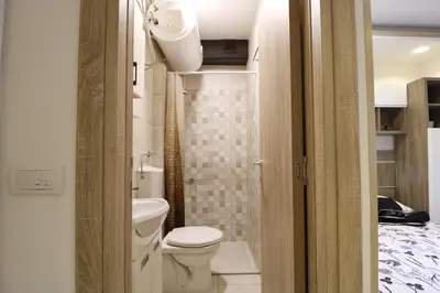 a small bathroom with a toilet and a sink at Studio Apartman Valdez 2 in Belgrade