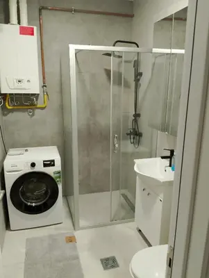 a bathroom with a washing machine and a sink at Amare2 in Inđija