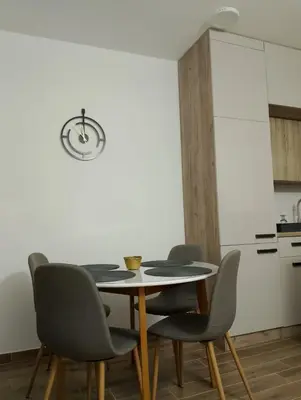 a dining room with a table and four chairs at Amare2 in Inđija