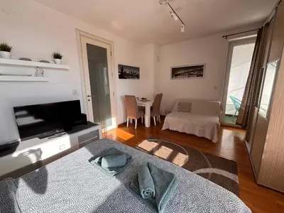 a living room with a television and a table at Belvil Belgrade in Belgrade