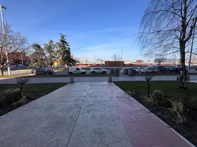 a walkway with cars parked in a parking lot at Belvil Belgrade in Belgrade
